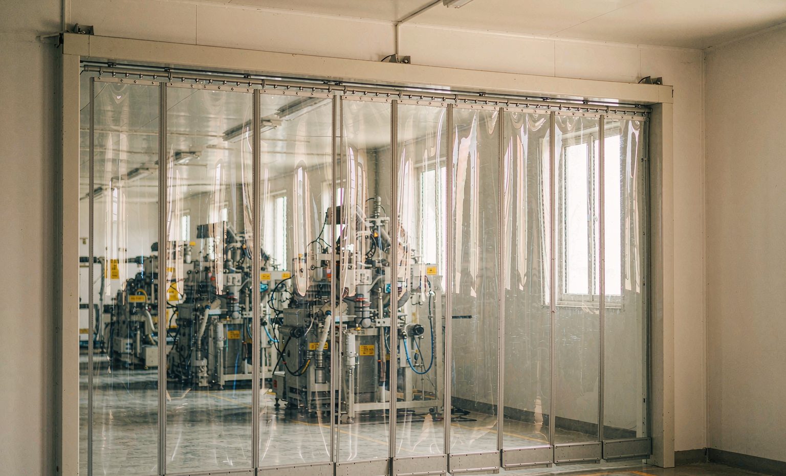 Inside the Bothwin plant: PVC strip curtains in a steel-framed doorway on the factory floor